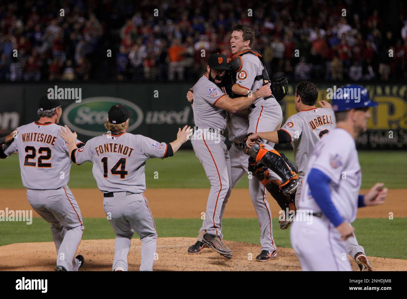 Buster Posey jumps into Brian Wilson's arms as the San Francisco