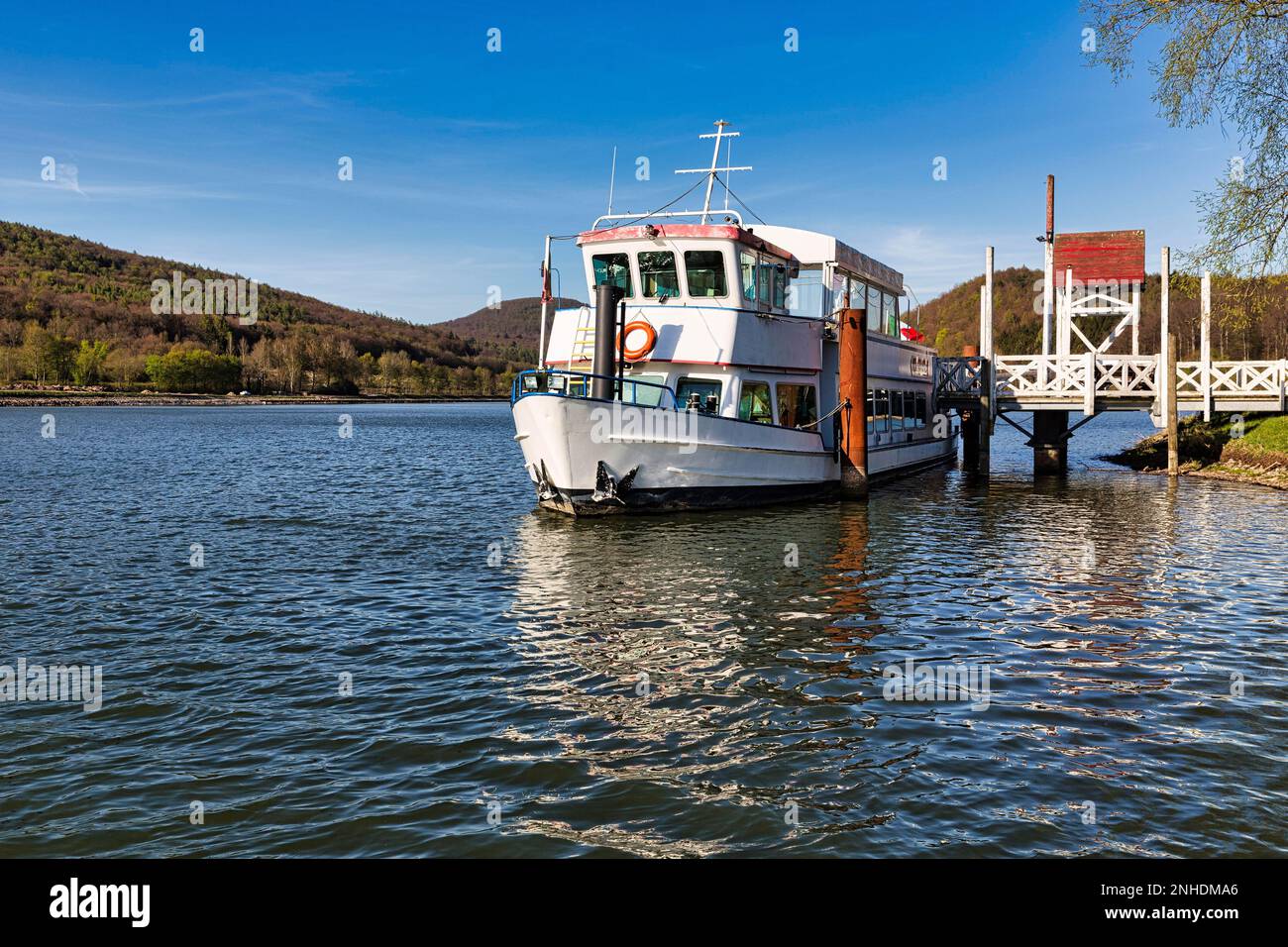 Round trip boat at the pier, recreation area Schiedersee, Emmerstausee, river Emmer, sunny spring weather, Schieder-Schwalenberg, nature park Stock Photo