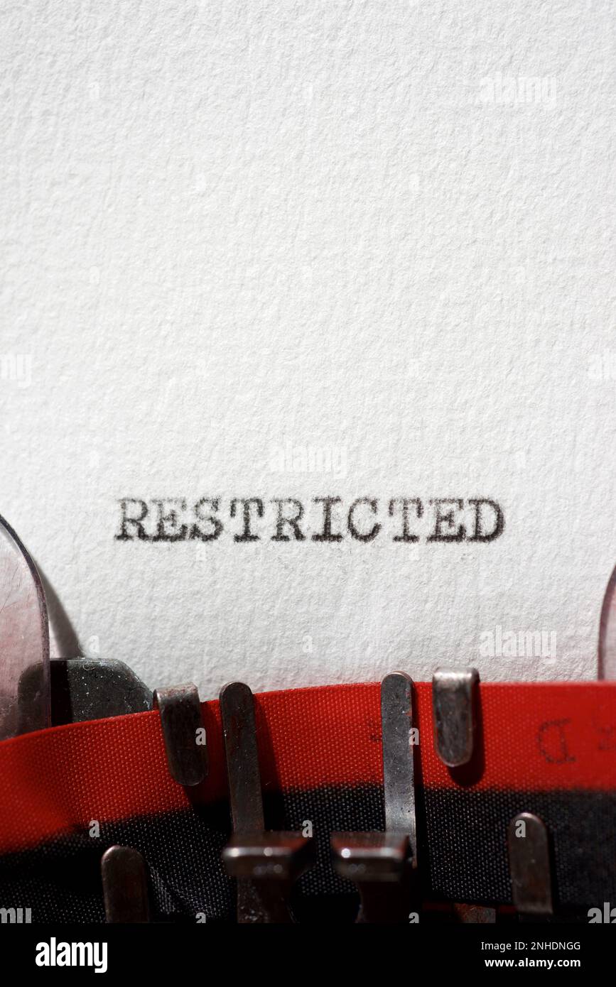 Restricted word written with a typewriter Stock Photo - Alamy