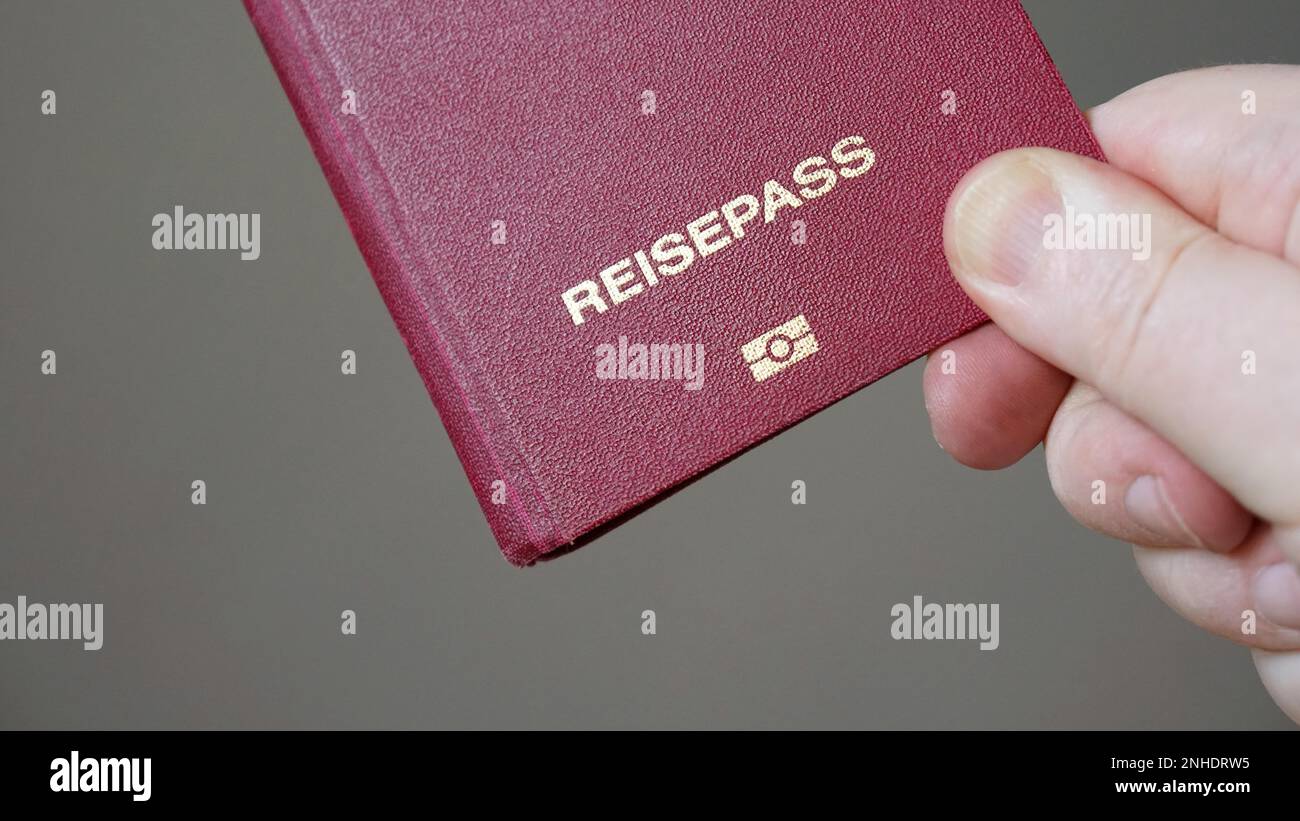Reisepass is German for passport - hand holding biometric e-passport from Germany Stock Photo