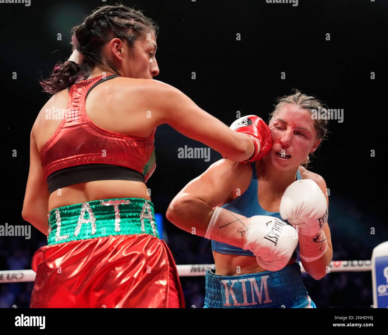Kim Clavel, right, of Canada, and Jessica Nery Plata, from Mexico, trade punches during the WBC/WBA junior flyweight title boxing bout Friday, Jan