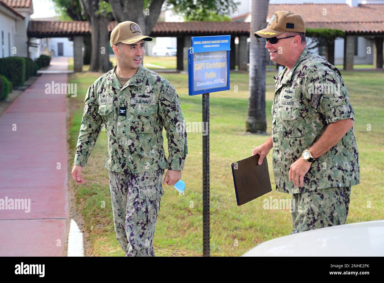 U.S. Navy Capt. Mike Aiena, commanding officer of Naval Surface Warfare Center, Corona Division, and Capt. Christopher Follin, commodore of Afloat Training Group Pacific, speak during a tour of the warfare center in Norco, California, July 28, 2022. As part of his visit to the warfare center, Follin was given an overview of the command and its role in Live, Virtual, Constructive training exercises. Stock Photo