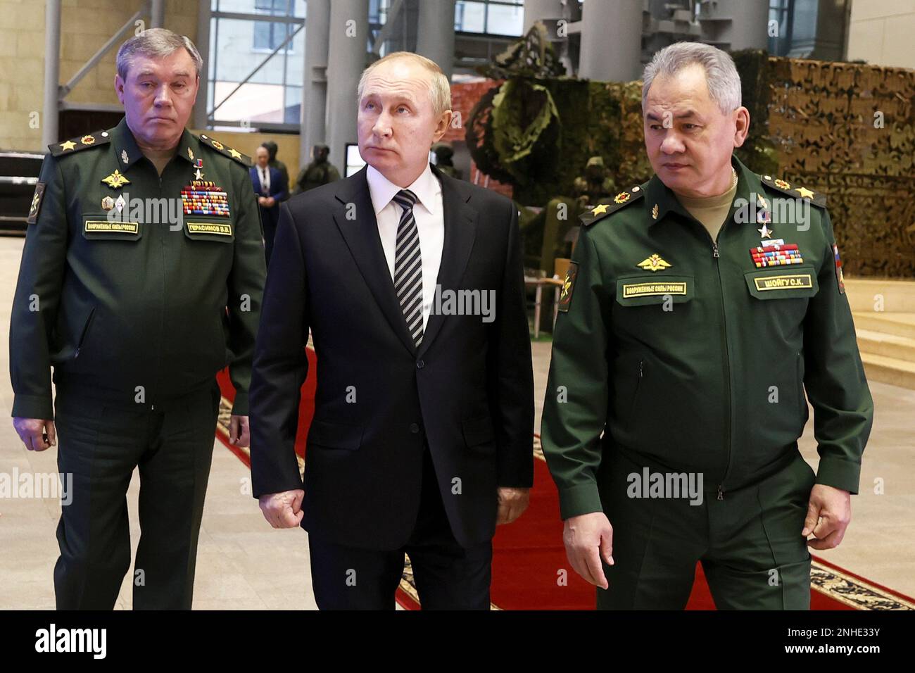 FILE - Russian President Vladimir Putin, center, escorted by Russian Defense Minister Sergei Shoigu, right, and General Staff Valery Gerasimov walk after attending an extended meeting of the Russian Defense Ministry Board at the National Defense Control Center in Moscow, Russia, Tuesday, Dec. 21, 2021. As Russian troops wage a ferocious house-to-house fight for control of strongholds in eastern Ukraine, a parallel battle is unfolding in the top echelons of military power in Moscow, with President Vladimir Putin reshuffling his top generals while rival camps try to win his favor. (Mikhail Metze Stock Photo