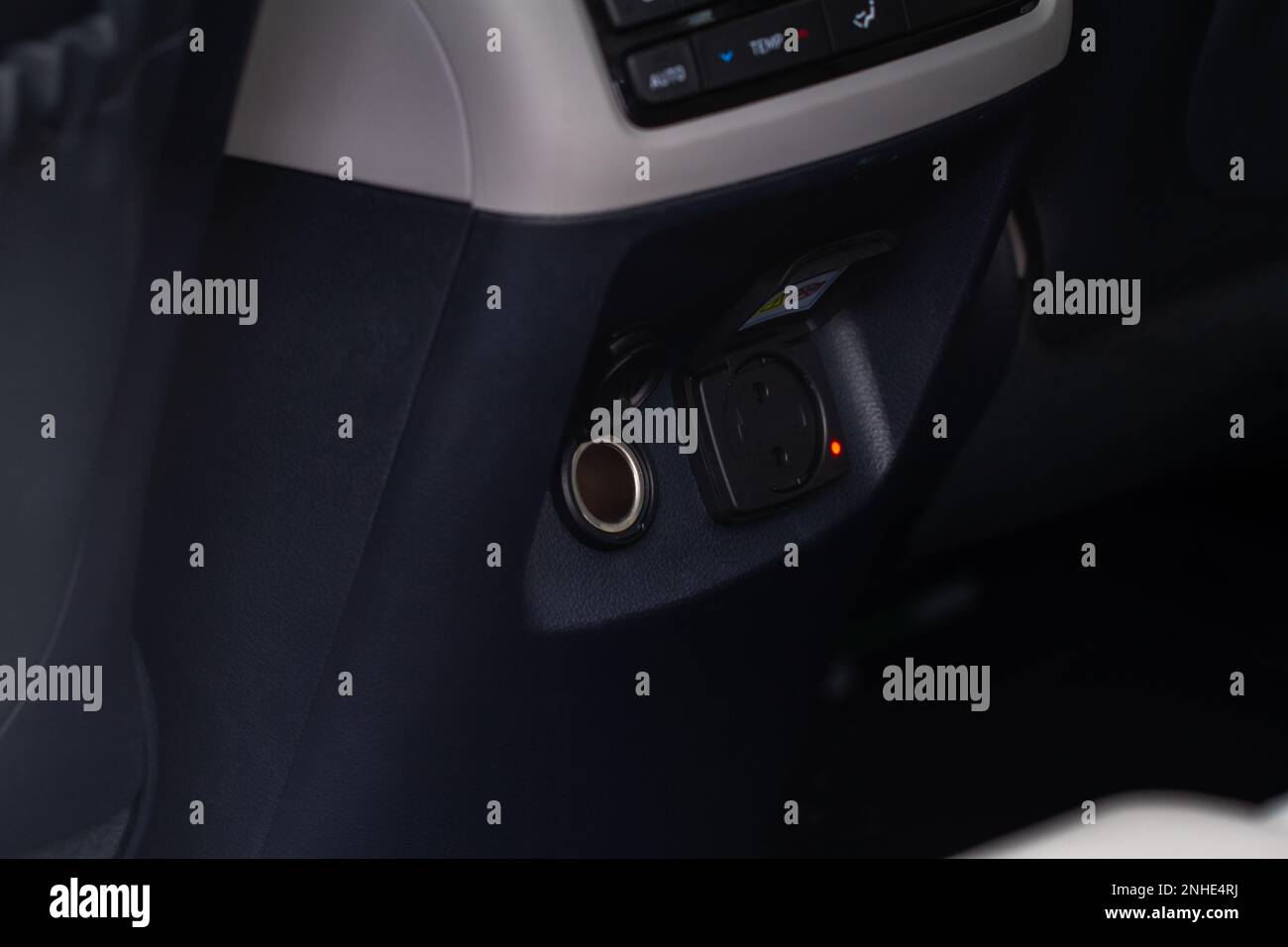 Modern car outlet socket. Opened 12V power outlet socket and 220v power outlet socket in the car