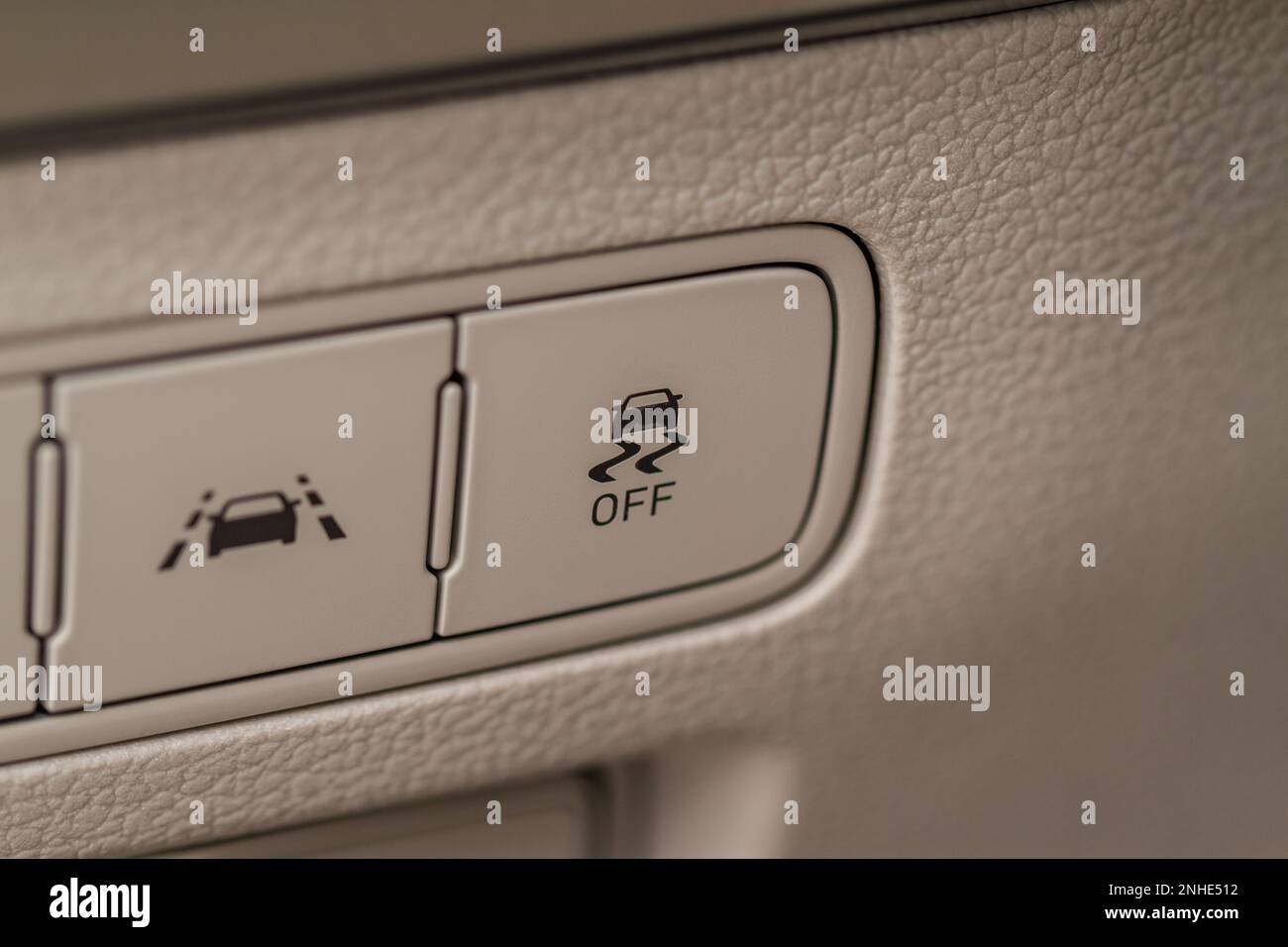 Hand operating ESP (electronic stability program) control close up view. Interior detail of a