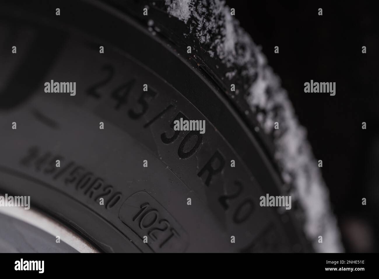 Close up view of snowy tire with tire width, height and wheel diameter