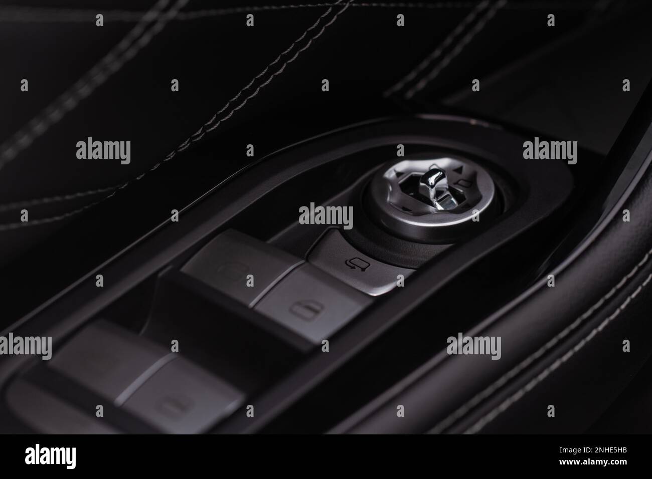 Side mirrors control panel on side door. Car driver adjust side mirror