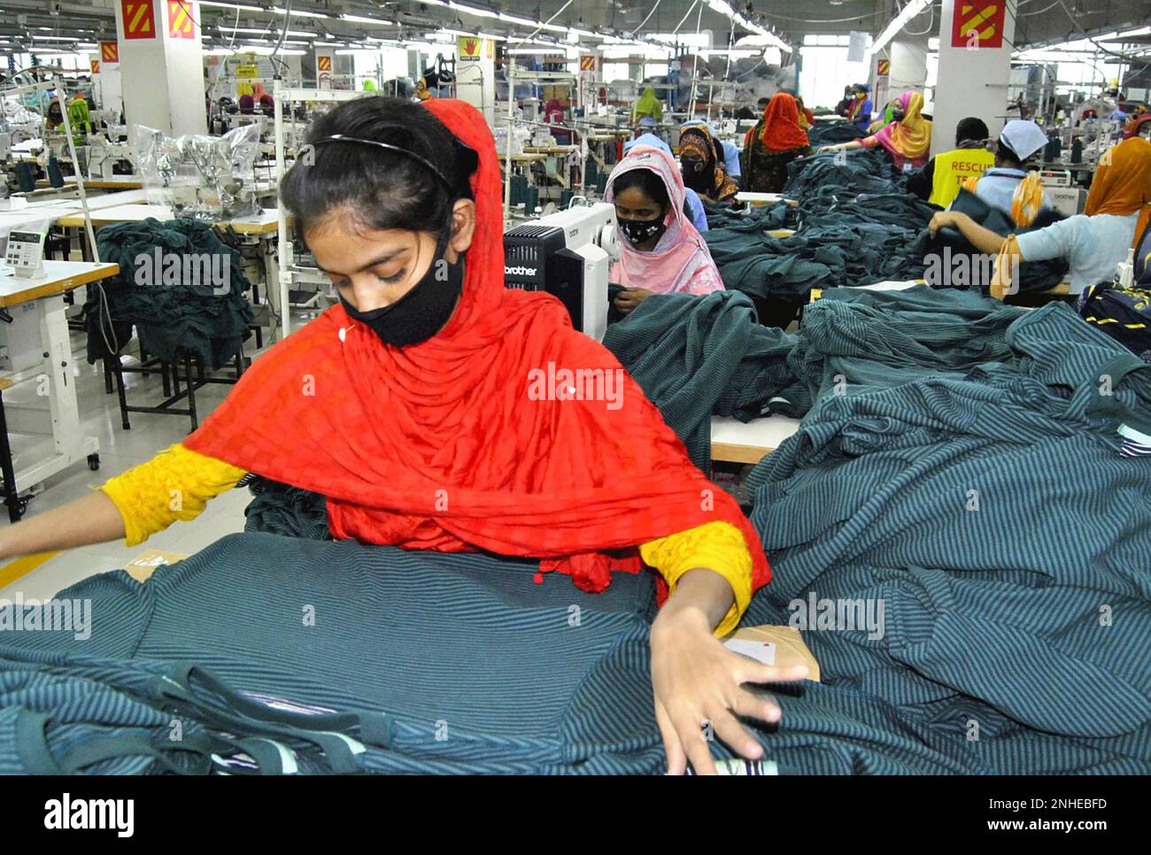 Workers saw items at a factory conducted by Japanese apparel maker