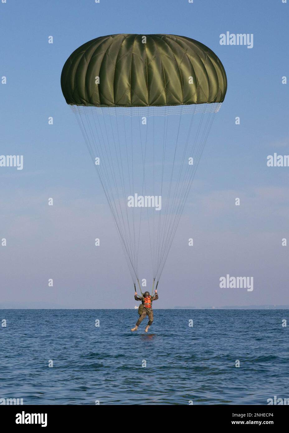 A German paratrooper lands during a water jump at Lake Constance