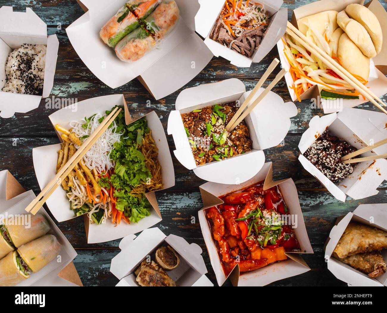 Assorted Chinese dishes in paper delivery boxes sweet and sour chicken