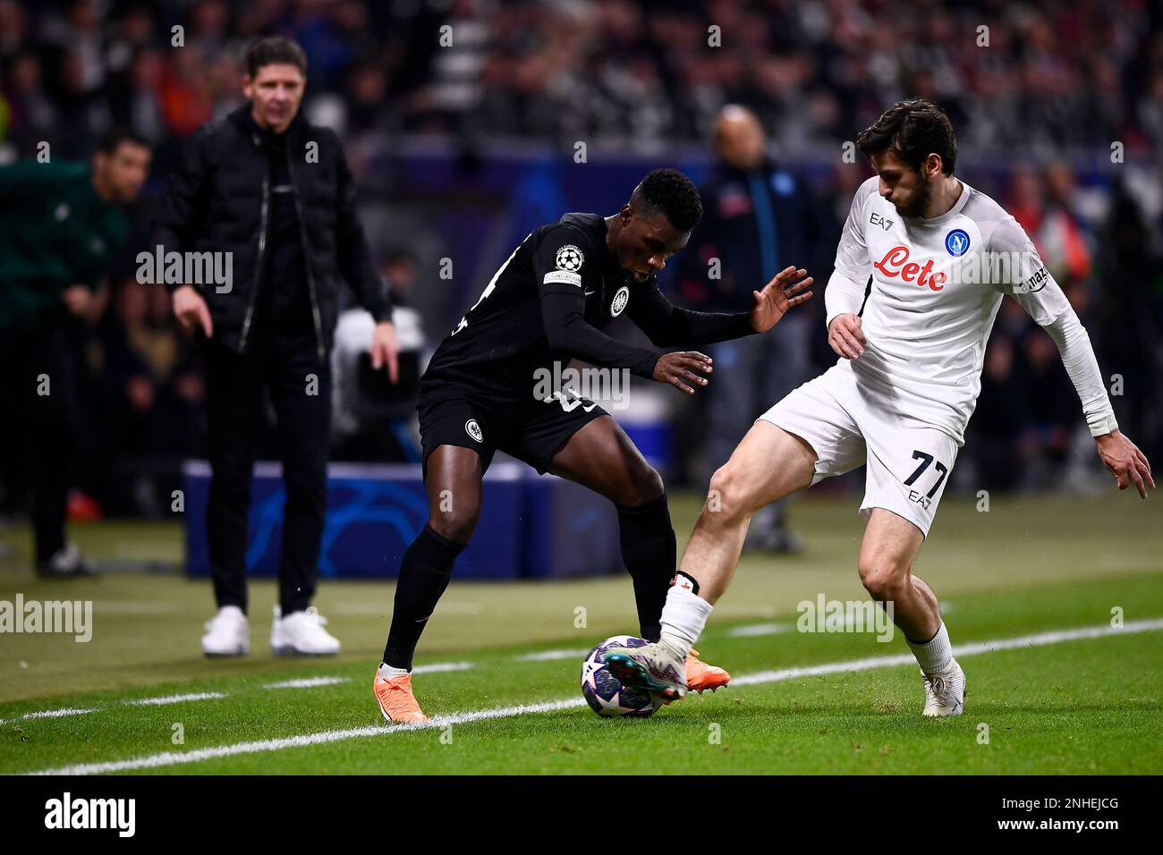 Frankfurt am Main, Germany. 21 February 2023. Aurelio Buta of Eintracht  Frankfurt competes for the ball with Khvicha Kvaratskhelia of SSC Napoli  during the UEFA Champions League round of 16 football match