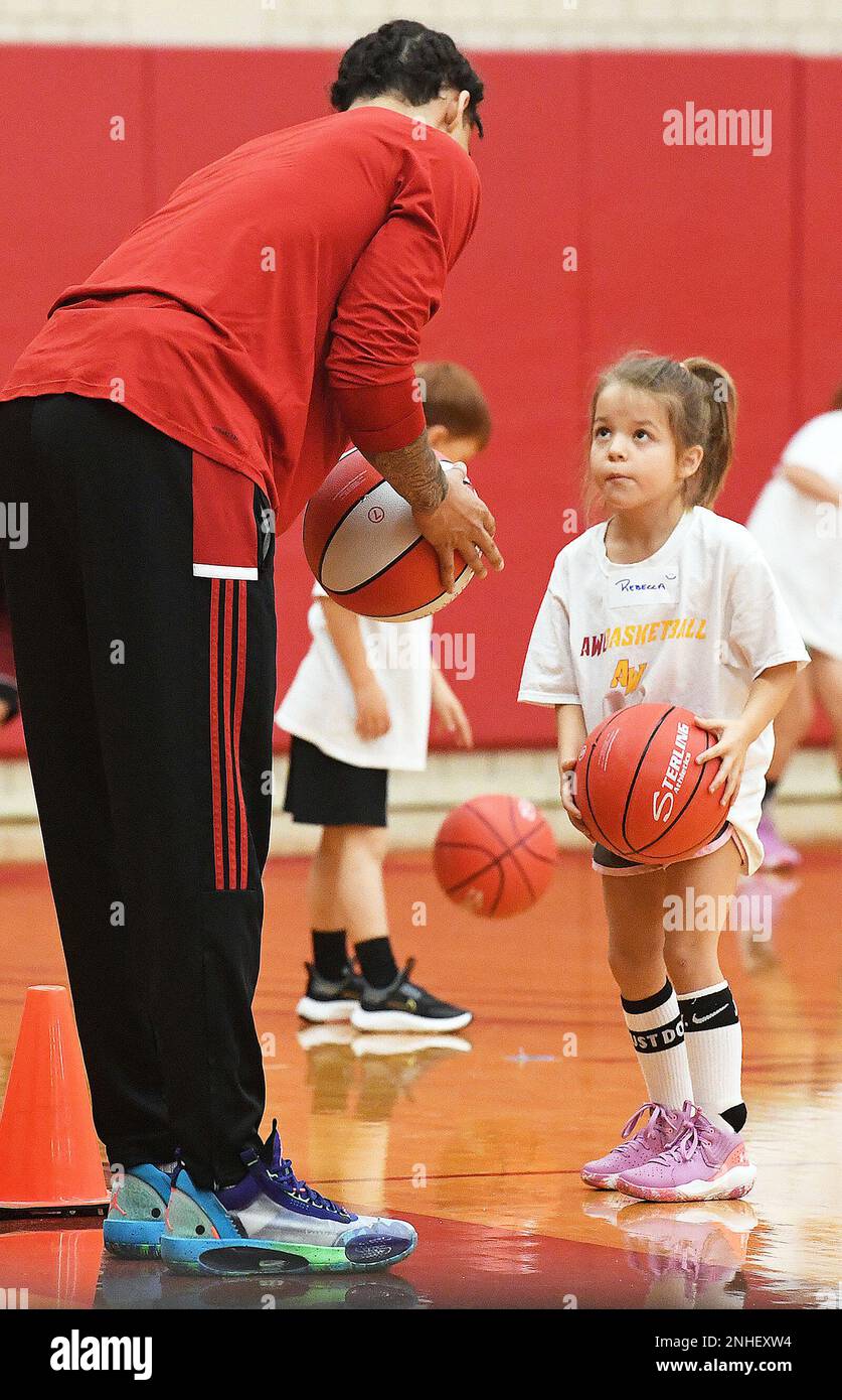 Rebecca Wort, right, looks up at 6foot5 Arizona Western College