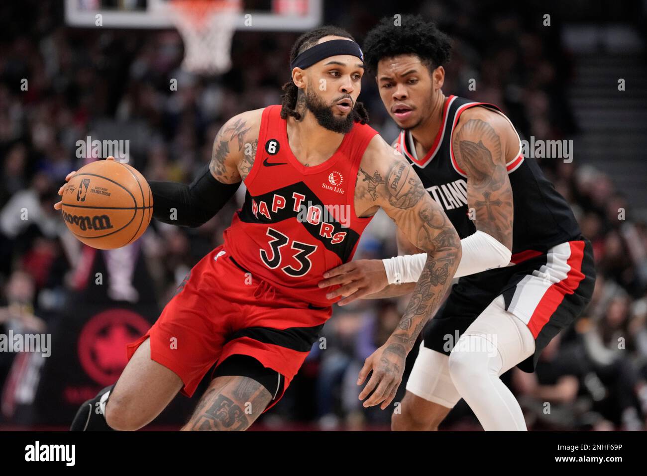 Toronto Raptors guard Gary Trent Jr. (33) controls the ball as Portland Trail  Blazers guard Anfernee Simons (1) defends during the second half of an NBA  basketball game in Toronto, Sunday, Jan.