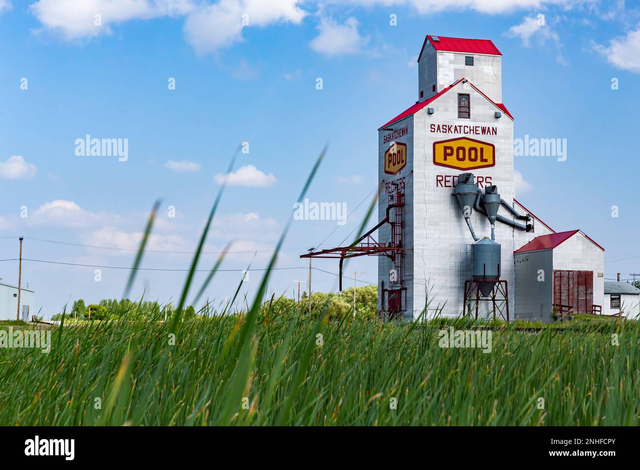 A grain elevator rises amid the greenery near the prairie town of Redvers, Saskatchewan (Canada). Stock Photo