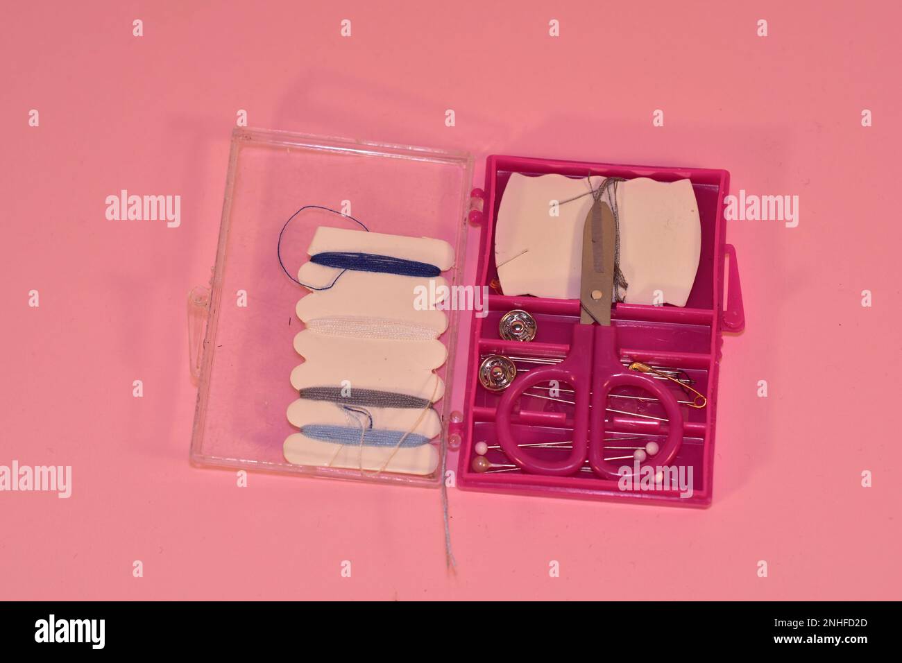 Mini sewing kit on a pink background Stock Photo