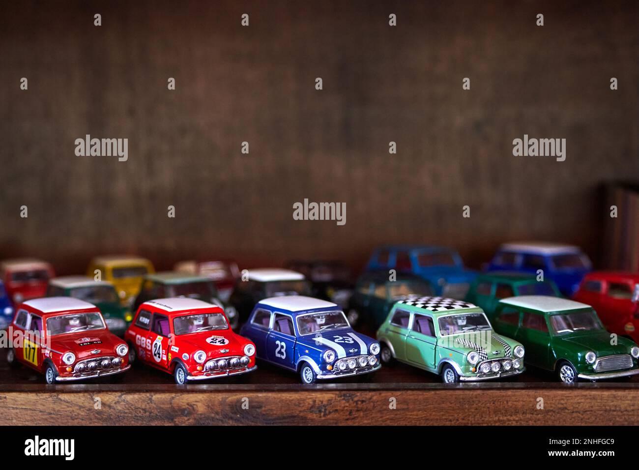 Miniature Mini Cooper cars on a wooden shelf Stock Photo