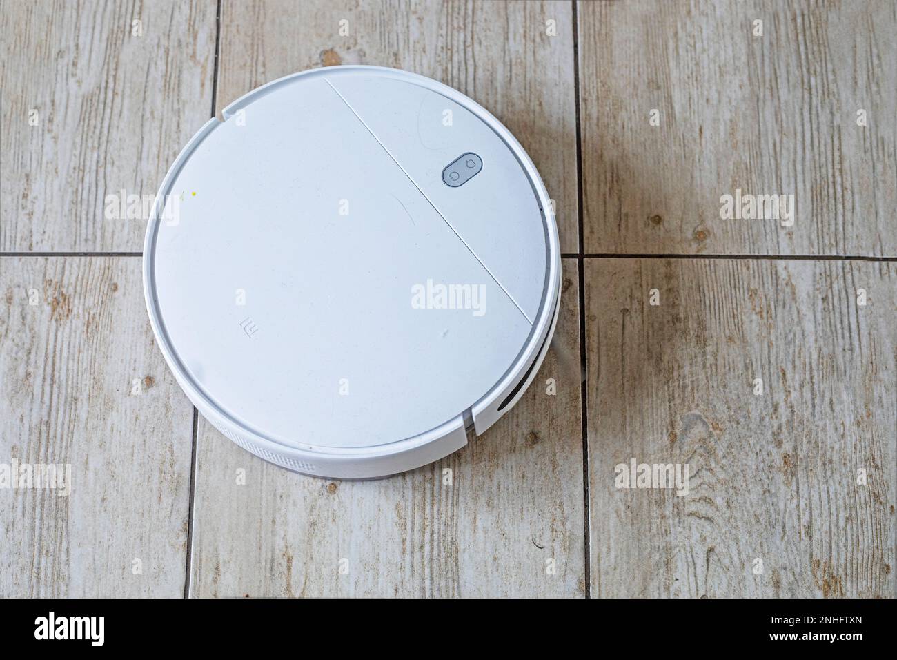 vacuum cleaner robot is automatically programmed to clean the room, flatlay Stock Photo