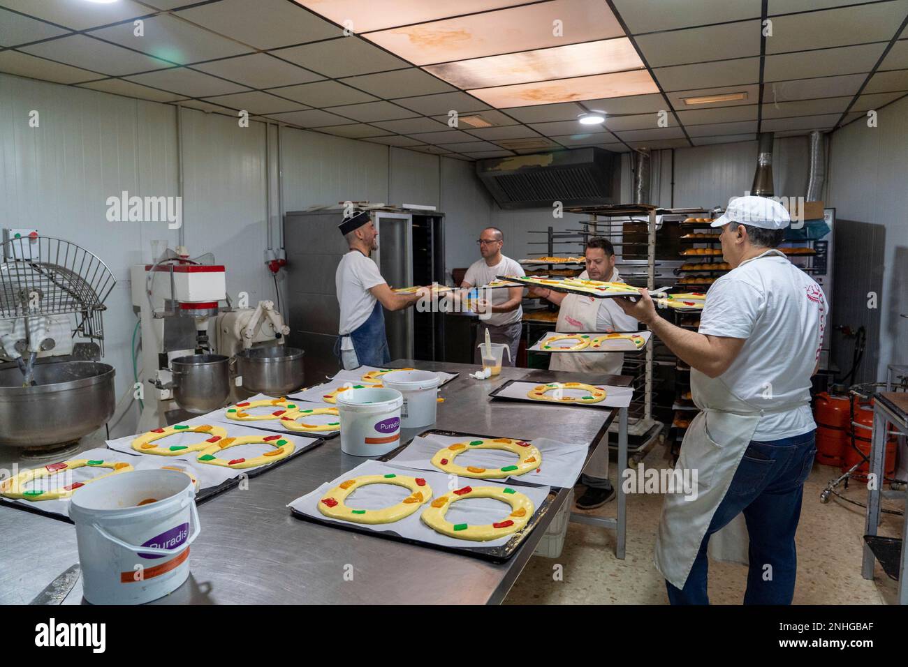 A pastry chef placing the Roscón de Reyes in the oven on January 3