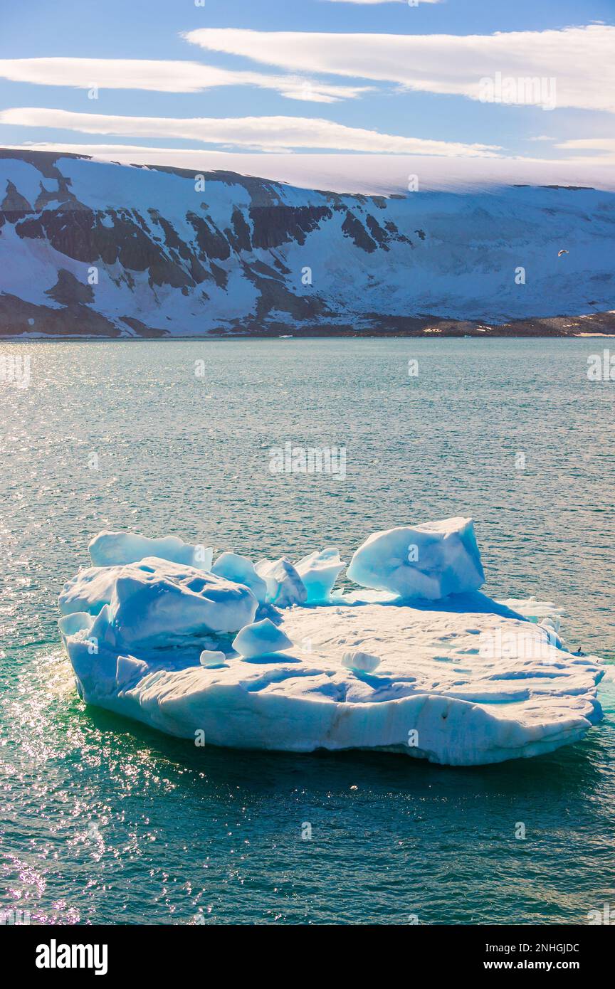 Iceberg floating in a fjord in the Svalbard Islands of  Norway Stock Photo