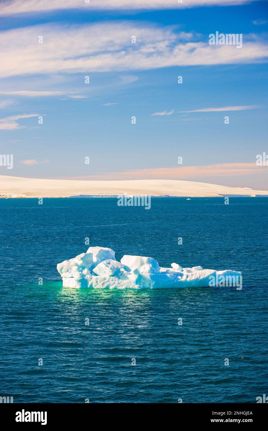 Iceberg floating in a fjord in the Svalbard Islands of  Norway Stock Photo