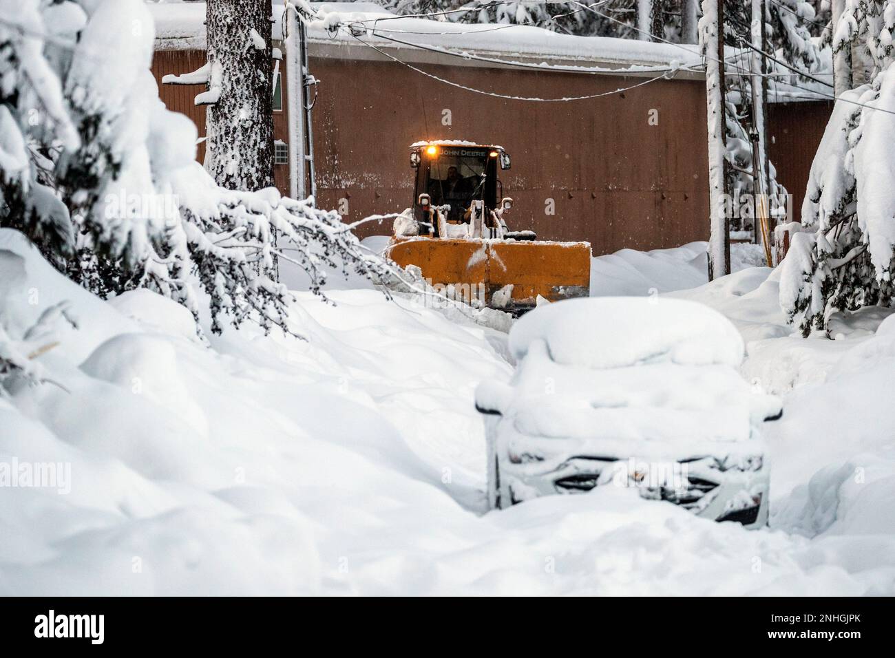 A snow plow works to clear snow on a road, the morning after a winter