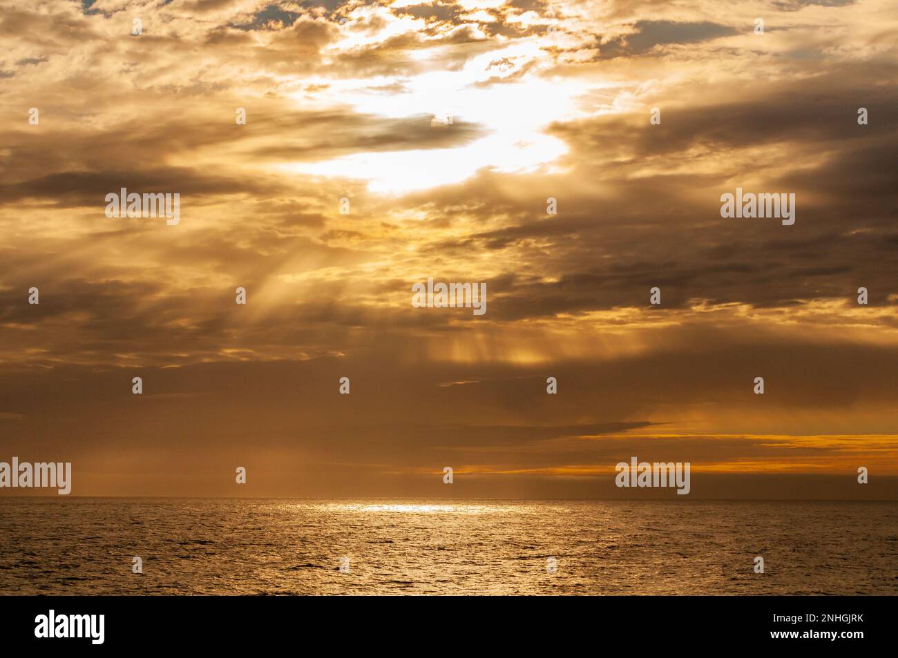 Beautiful sunset through clouds over the Arctic Ocean near the Svalbard Islands of Norway Stock Photo