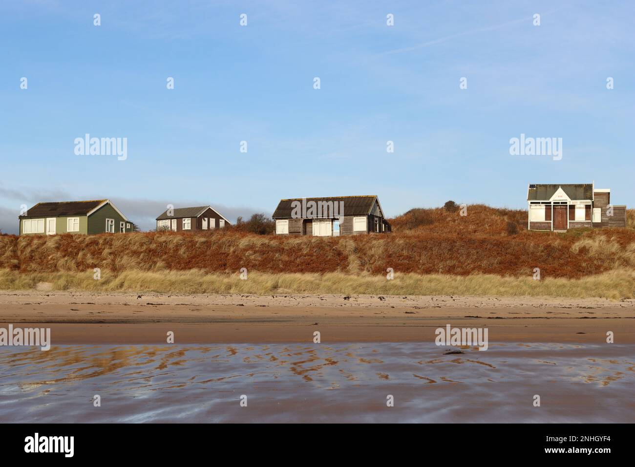 Beach huts in the sand dunes at Low Newton by the Sea, Northumberland