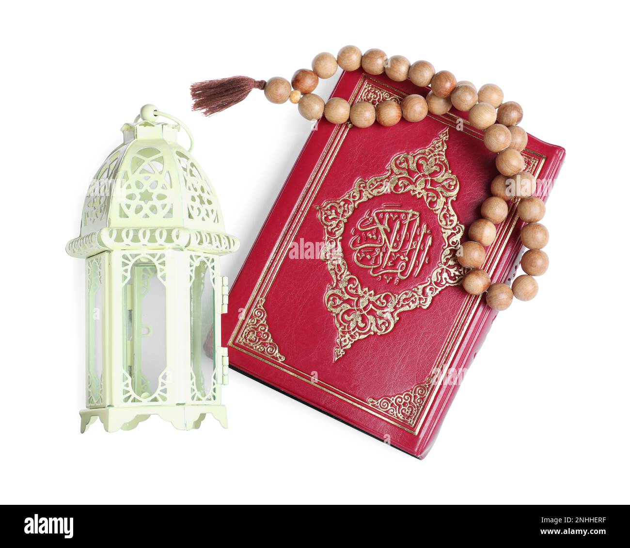 Decorative Arabic lantern, Quran and prayer beads on white background