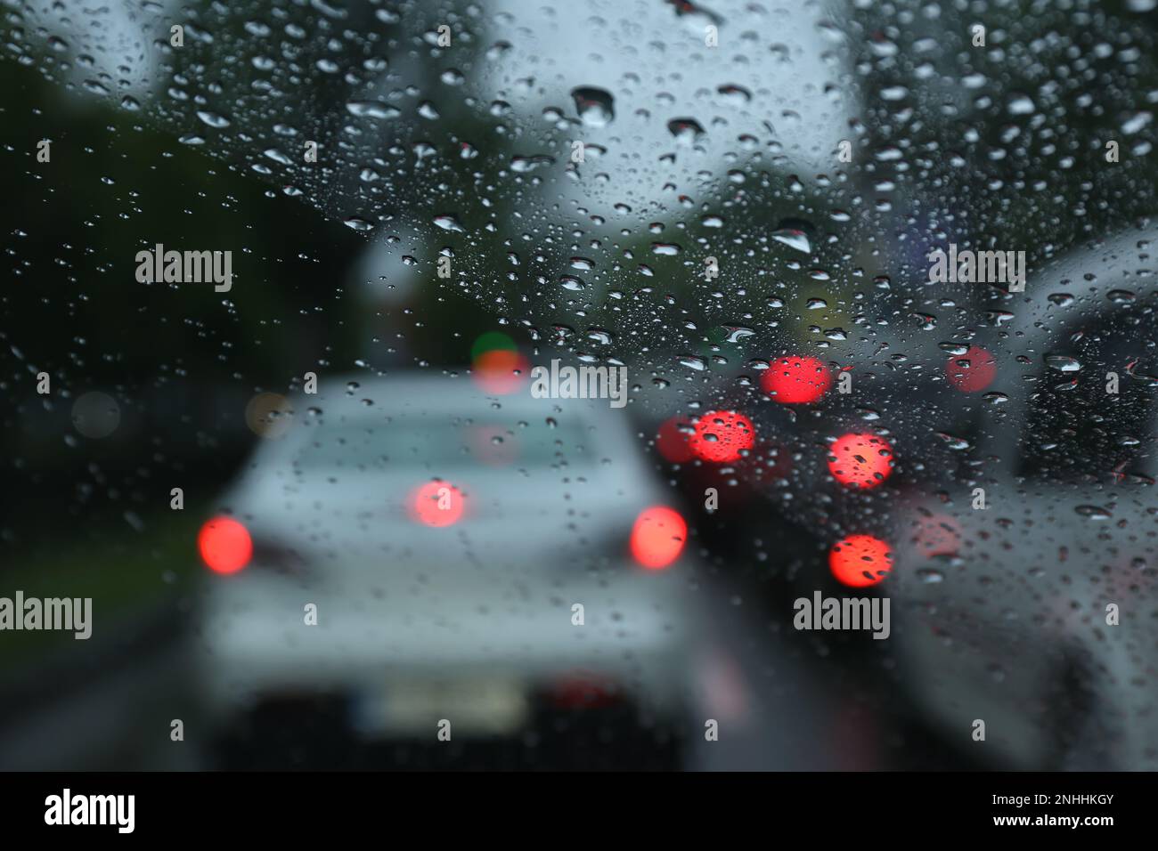 Blurred view of road through wet car window. Rainy weather Stock Photo ...