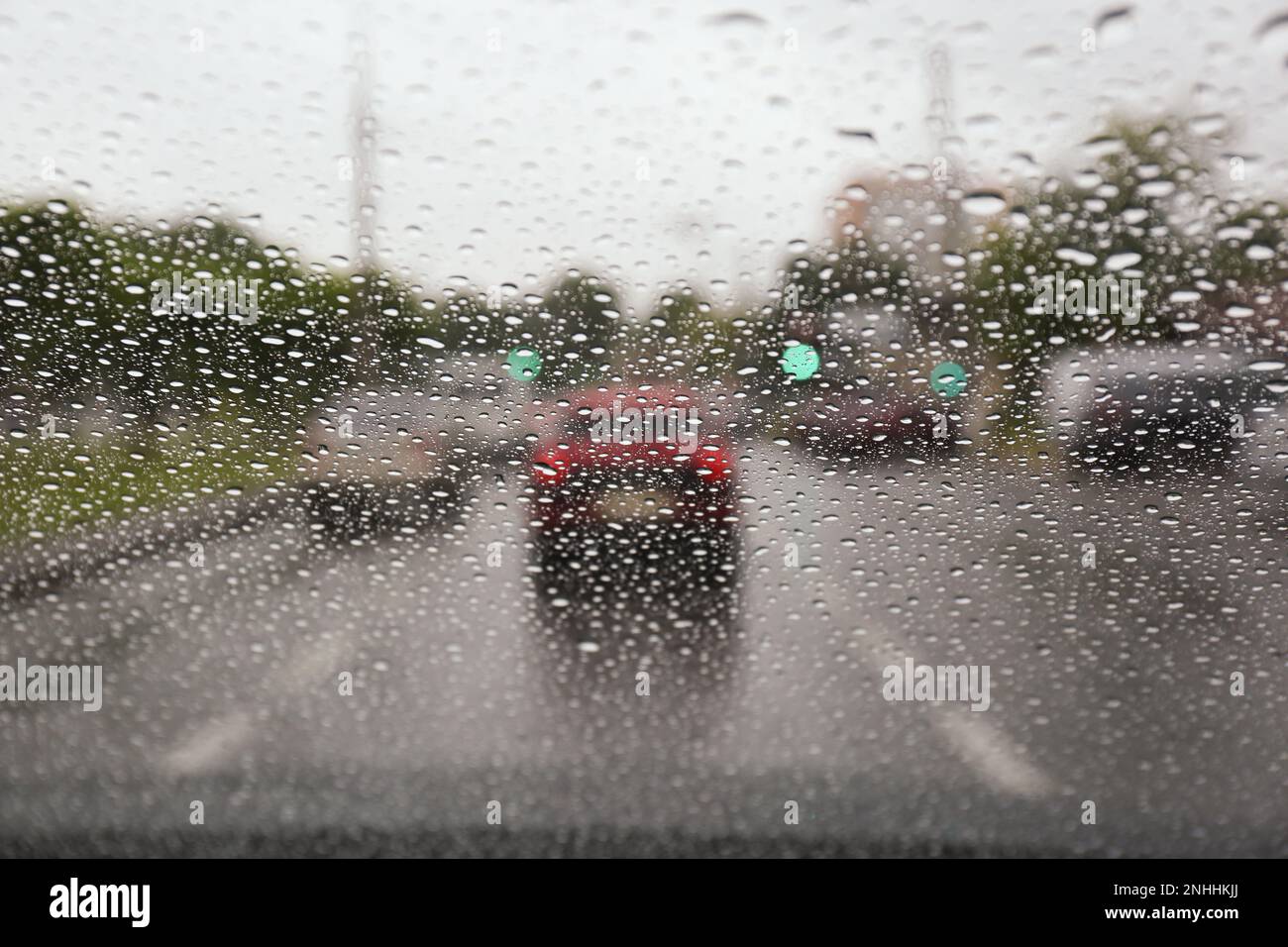 Blurred view of road through wet car window. Rainy weather Stock Photo ...