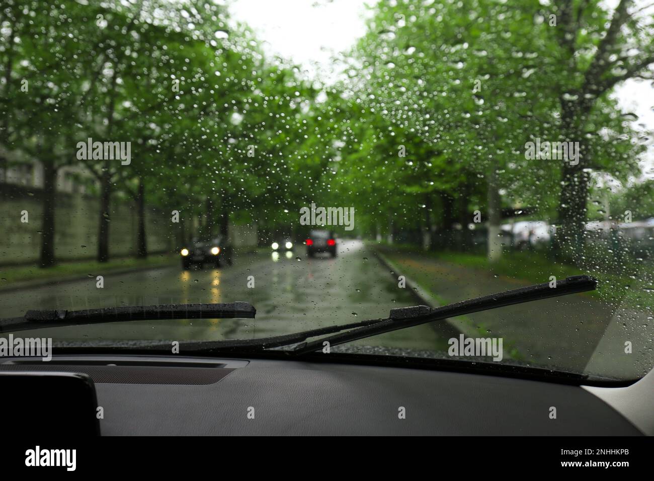 Blurred view of road through wet car window. Rainy weather Stock Photo ...