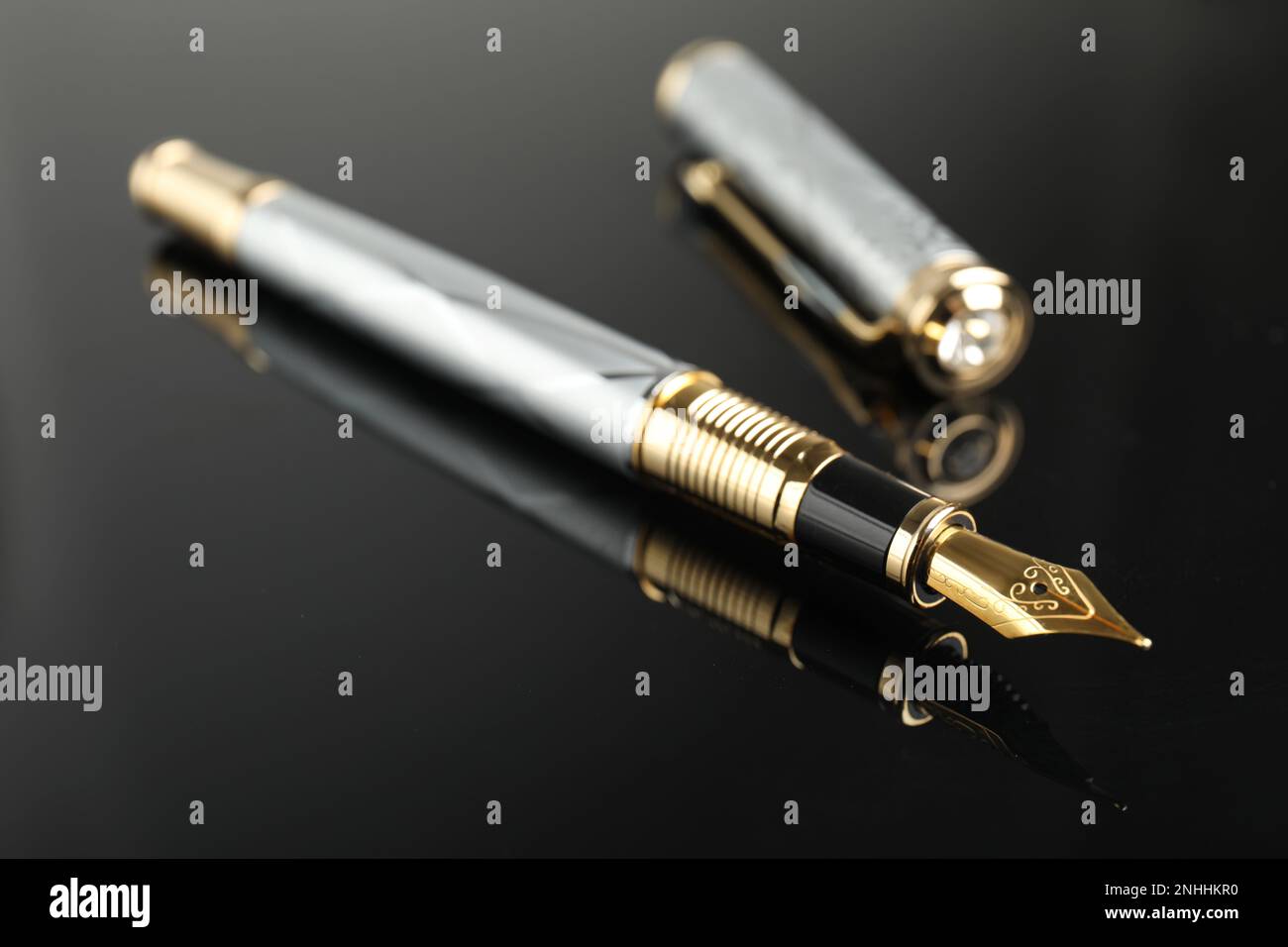 Beautiful fountain pen with ornate nib on black background, closeup ...
