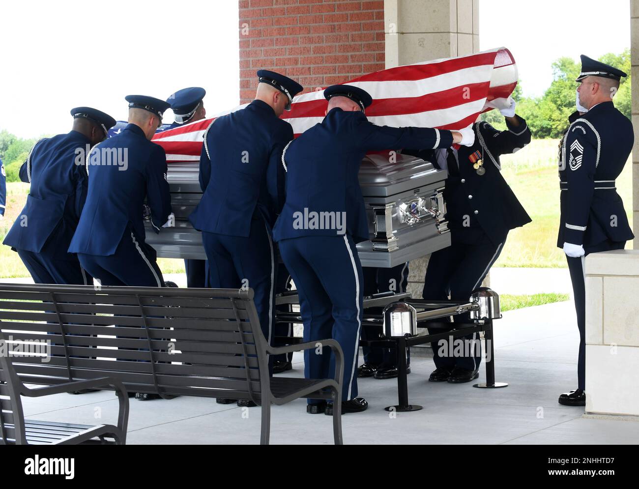 United States Air Force Honor Guard lowers the casket of the sixth