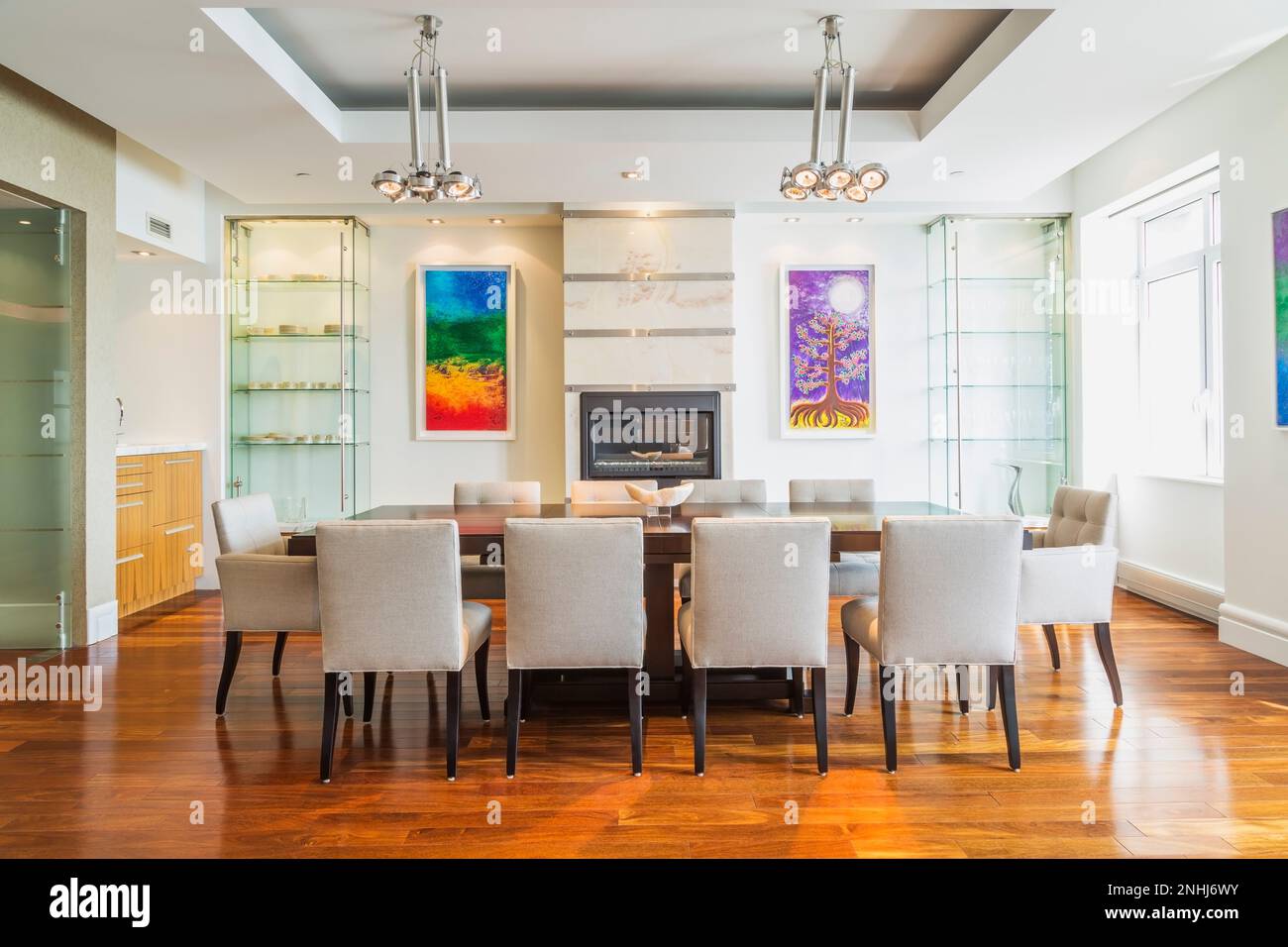 Dark wood dining table with grey upholstered cloth chairs in dining room with Brazilian Ipe wood