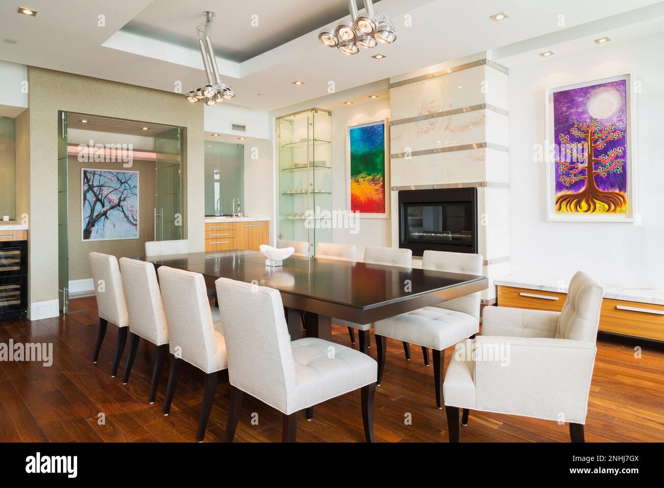 Dark wood dining table with grey upholstered cloth chairs in dining