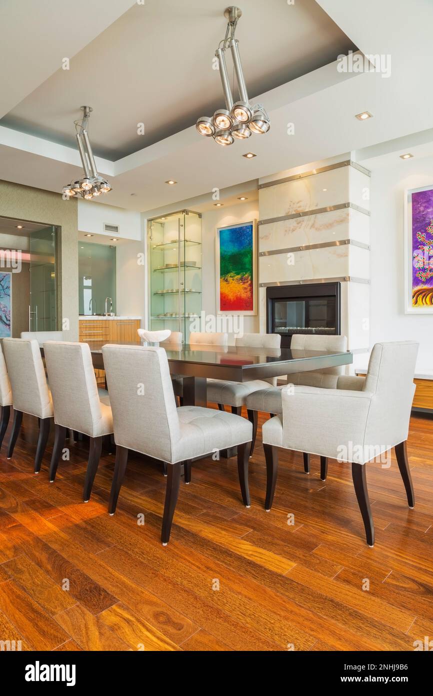 Dark wood dining table with grey upholstered cloth chairs in dining