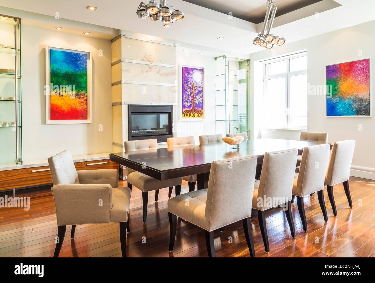 Dark wood dining table with grey upholstered cloth chairs in dining