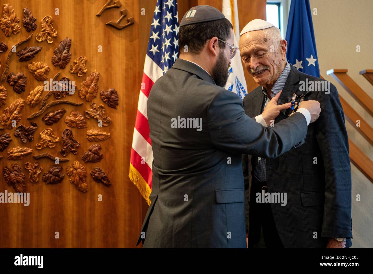 U.S. Army Air Corps 1st Lt. Gerald Teldon (right), retired, receives his award from his grandson, Rabbi Mendel Teldon, for his honorable service as a pilot on July 29, 2022, at the Chabad Center for Jewish Life and Learning, San Antonio, Texas. Teldon, born in Bronx, N.Y., in 1924, joined the military in 1944. He completed 62 missions during WWII and the Korean War. Lt. Col. Andrew Stein, 502nd Operations Support Squadron commander, was the presiding officers. The awards presented to Teldon are as follows: the Air Medal; American Campaign Medal; European – African – Middle Eastern Campaign Med Stock Photo