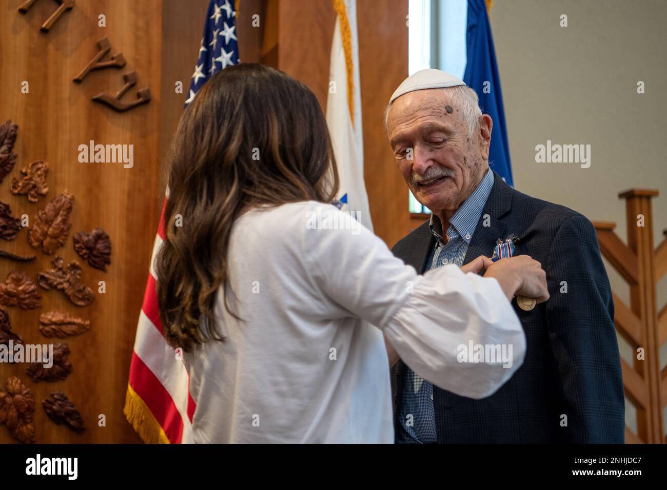U.S. Army Air Corps 1st Lt. Gerald Teldon (right), retired, receives his award from his granddaughter, Chanie Kamman, for his honorable service as a pilot on July 29, 2022, at the Chabad Center for Jewish Life and Learning, San Antonio, Texas. Teldon, born in Bronx, N.Y., in 1924, joined the military in 1944. He completed 62 missions during WWII and the Korean War. Lt. Col. Andrew Stein, 502nd Operations Support Squadron commander, was the presiding officers. The awards presented to Teldon are as follows: the Air Medal; American Campaign Medal; European – African – Middle Eastern Campaign Meda Stock Photo