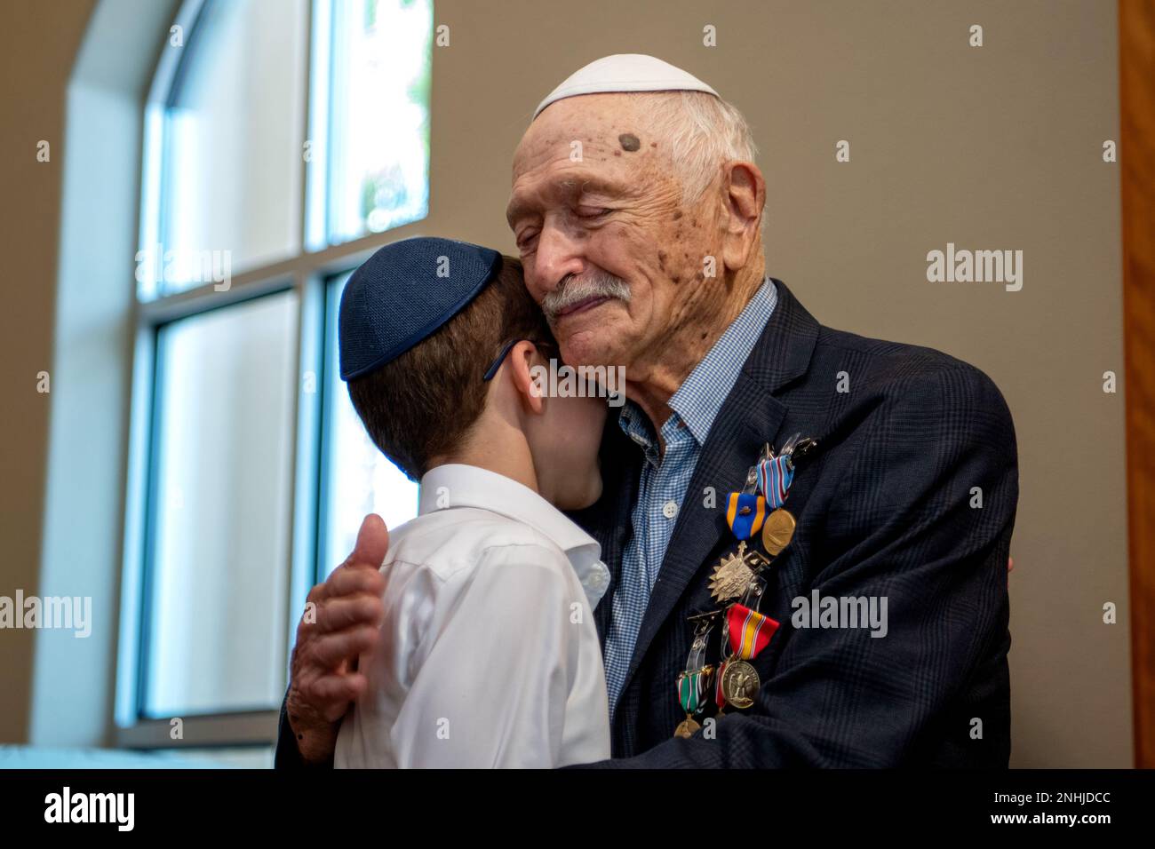 U.S. Army Air Corps 1st Lt. Gerald Teldon (right), retired, receives his ribbons from his great grandson, Menachem Mendel Teldon, for his honorable service as a pilot on July 29, 2022, at the Chabad Center for Jewish Life and Learning, San Antonio, Texas. Teldon, born in Bronx, N.Y., in 1924, joined the military in 1944. He completed 62 missions during WWII and the Korean War. Lt. Col. Andrew Stein, 502nd Operations Support Squadron commander, was the presiding officers. The awards presented to Teldon are as follows: the Air Medal; American Campaign Medal; European – African – Middle Eastern C Stock Photo
