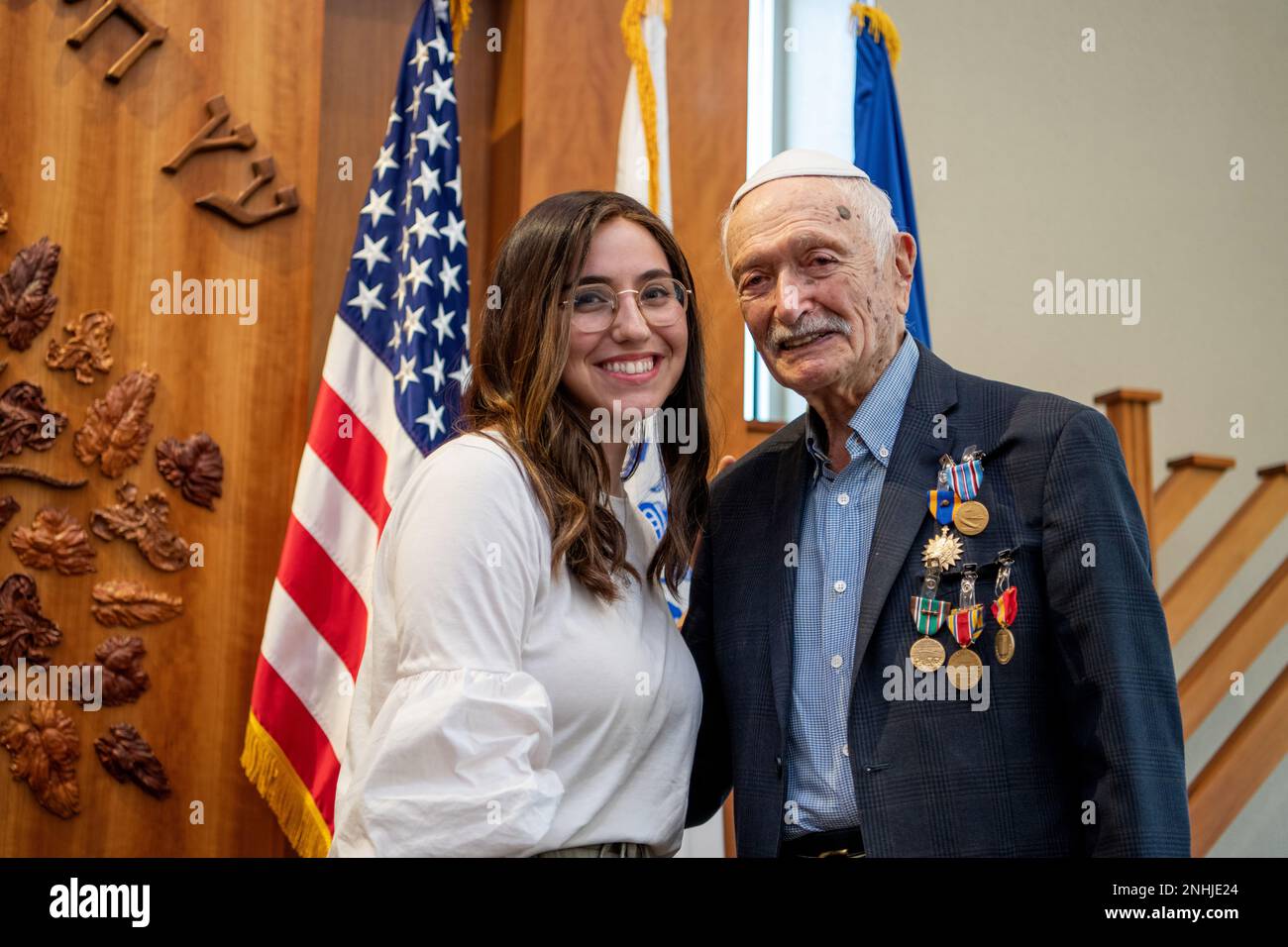U.S. Army Air Corps 1st Lt. Gerald Teldon (right), retired, receives his award from his granddaughter, Chanie Kamman, for his honorable service as a pilot on July 29, 2022, at the Chabad Center for Jewish Life and Learning, San Antonio, Texas. Teldon, born in Bronx, N.Y., in 1924, joined the military in 1944. He completed 62 missions during WWII and the Korean War. Lt. Col. Andrew Stein, 502nd Operations Support Squadron commander, was the presiding officers. The awards presented to Teldon are as follows: the Air Medal; American Campaign Medal; European – African – Middle Eastern Campaign Meda Stock Photo