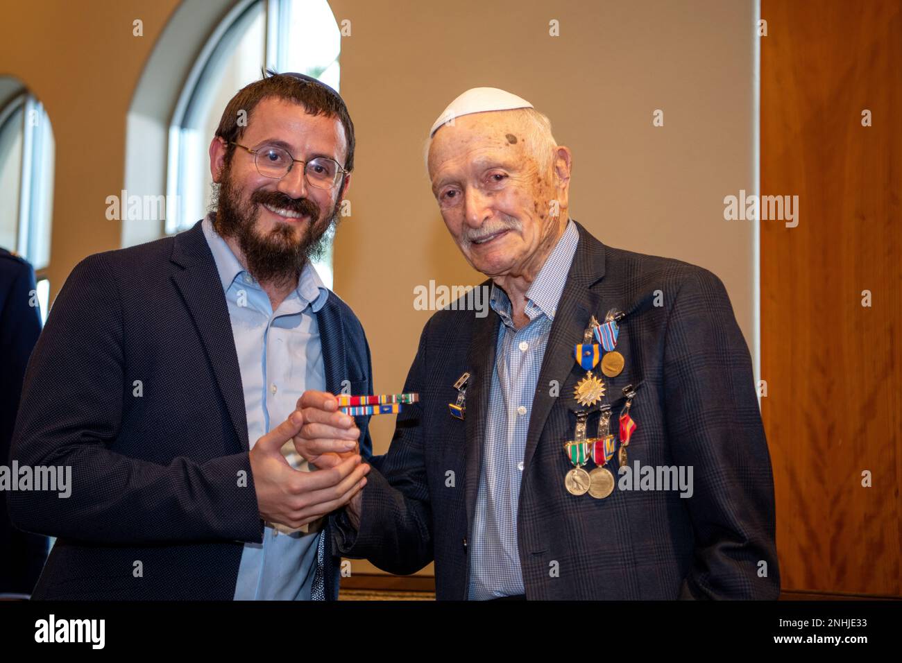 U.S. Army Air Corps 1st Lt. Gerald Teldon (right), retired, receives his ribbons from his grandson, Rabbi Moshe Teldon, for his honorable service as a pilot on July 29, 2022, at the Chabad Center for Jewish Life and Learning, San Antonio, Texas. Teldon, born in Bronx, N.Y., in 1924, joined the military in 1944. He completed 62 missions during WWII and the Korean War. Lt. Col. Andrew Stein, 502nd Operations Support Squadron commander, was the presiding officers. The awards presented to Teldon are as follows: the Air Medal; American Campaign Medal; European – African – Middle Eastern Campaign Me Stock Photo