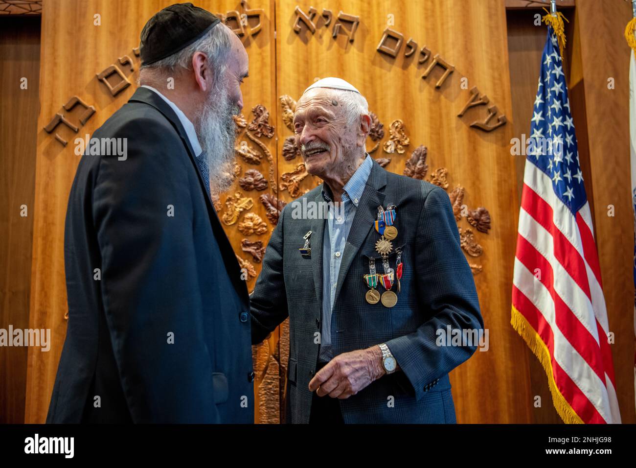 Rabbi Tuvia Teldon (left) congratulates his father, U.S. Army Air Corps 1st Lt. Gerald Teldon, retired, for his honorable service as a pilot on July 29, 2022, at the Chabad Center for Jewish Life and Learning, San Antonio, Texas. Teldon, born in Bronx, N.Y., in 1924, joined the military in 1944. He completed 62 missions during WWII and the Korean War. Lt. Col. Andrew Stein, 502nd Operations Support Squadron commander, was the presiding officers. The awards presented to Teldon are as follows: the Air Medal; American Campaign Medal; European – African – Middle Eastern Campaign Medal; World War I Stock Photo
