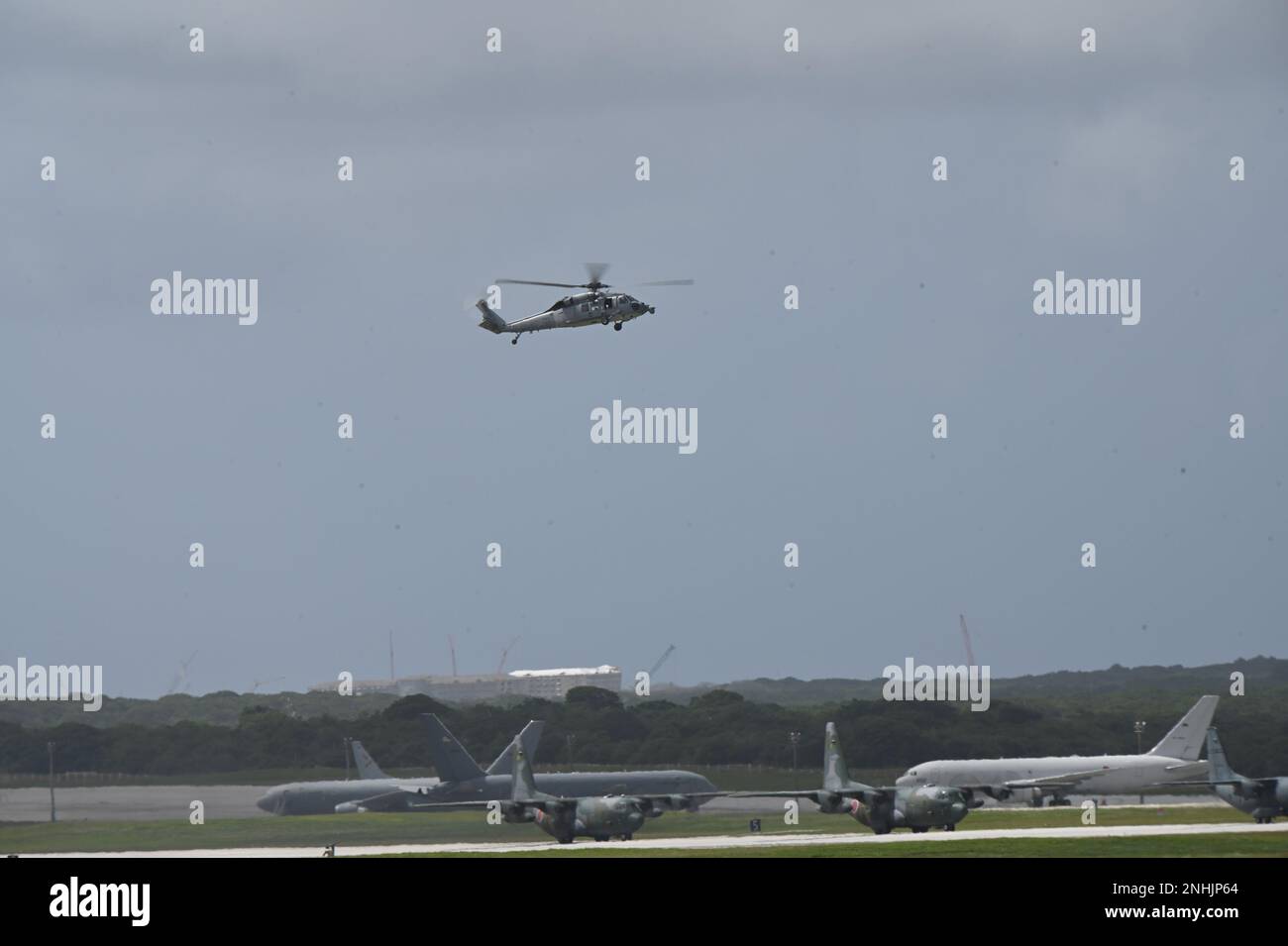 A U.S. Navy Sikorsky SH-60 Seahawk from the Helicopter Sea Combat Squadron 25 (HSC-25) hovers above an airfield at Andersen Air Force Base, Guam, during Cope North 2023, Feb. 9, 2023. Exercises like Cope North allow the Pacific Air Forces to validate new ways to deploy and maneuver assets. (U.S. Air National Guard photo by Senior Airman Christa Anderson) Stock Photo