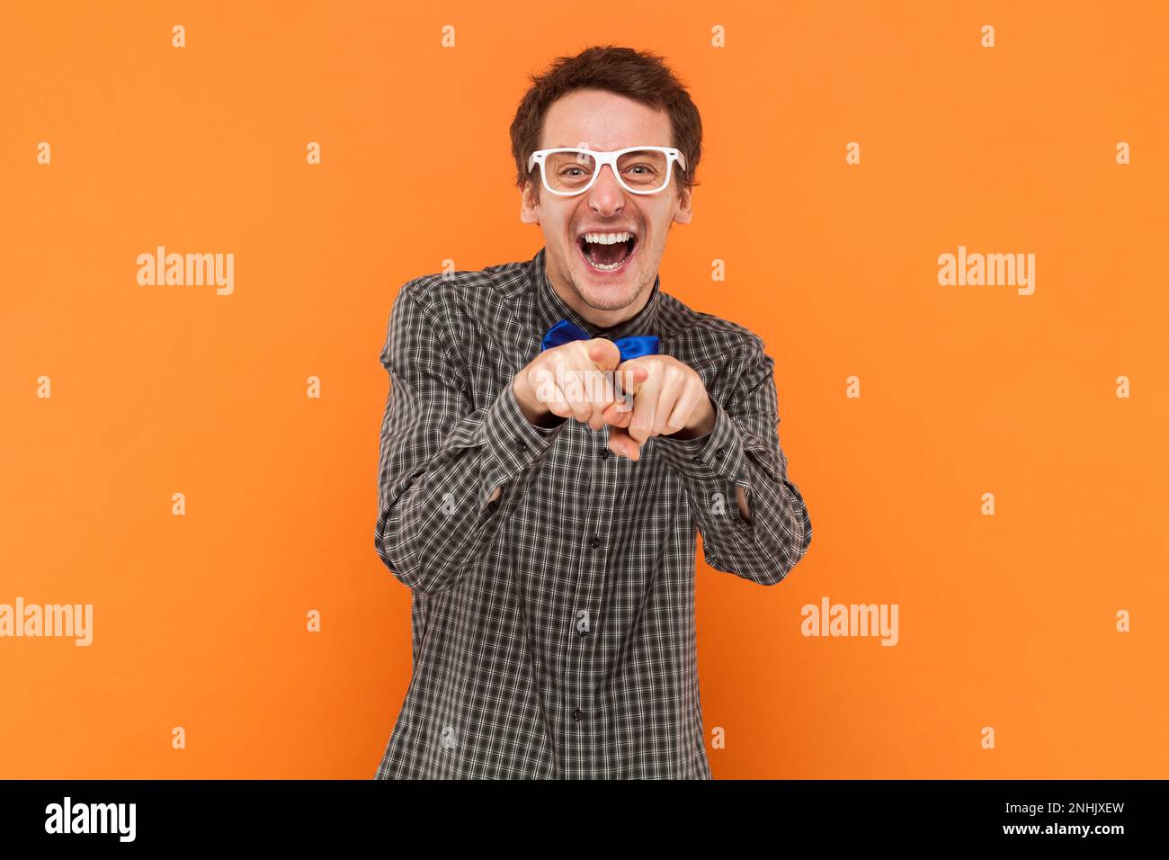 Overjoyed man nerd laughs at something funny, points directly into