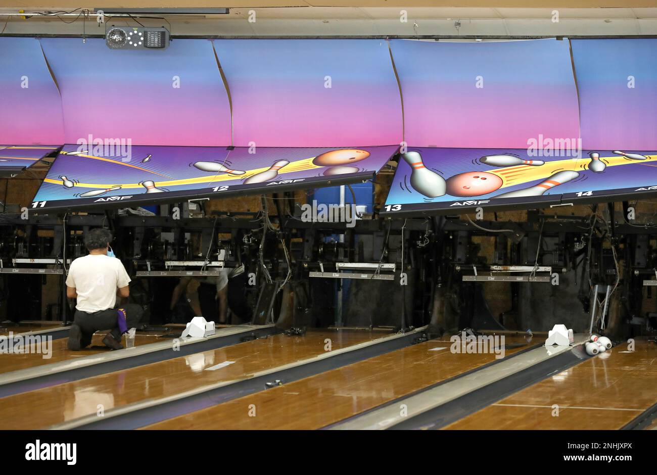 Head mechanic Antonio Ledezma (left) removes several pinsetters at 