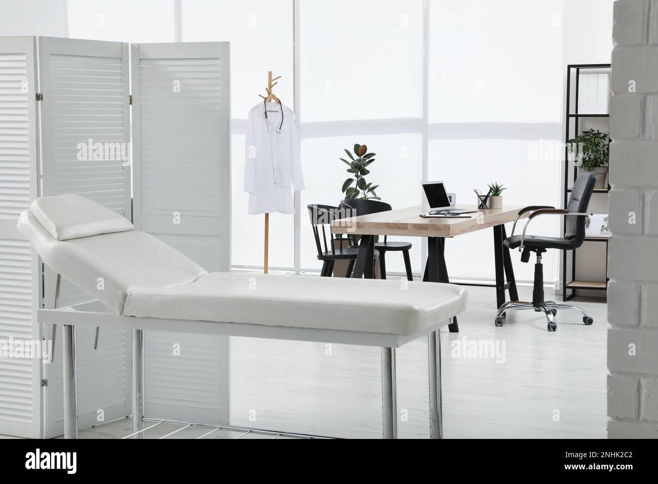 Modern medical office interior with couch. Doctor's workplace Stock