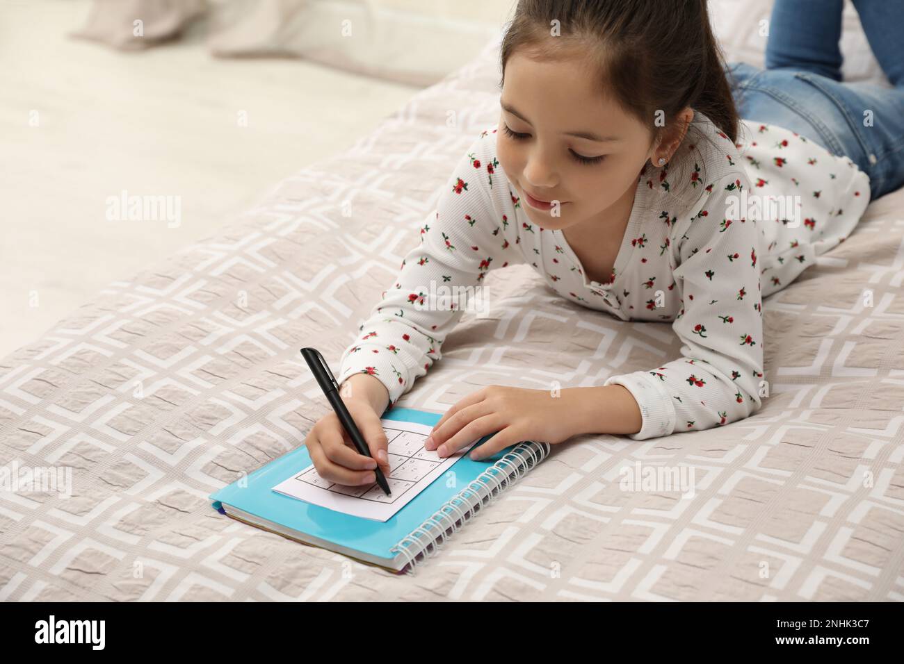 Little Girl Solving Sudoku Puzzle On Bed At Home Stock Photo Alamy Little girl solving sudoku puzzle on bed at home stock photo alamy