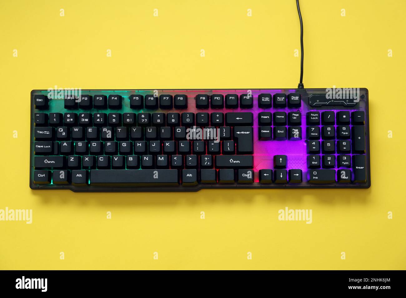 Modern RGB keyboard on yellow background, top view Stock Photo