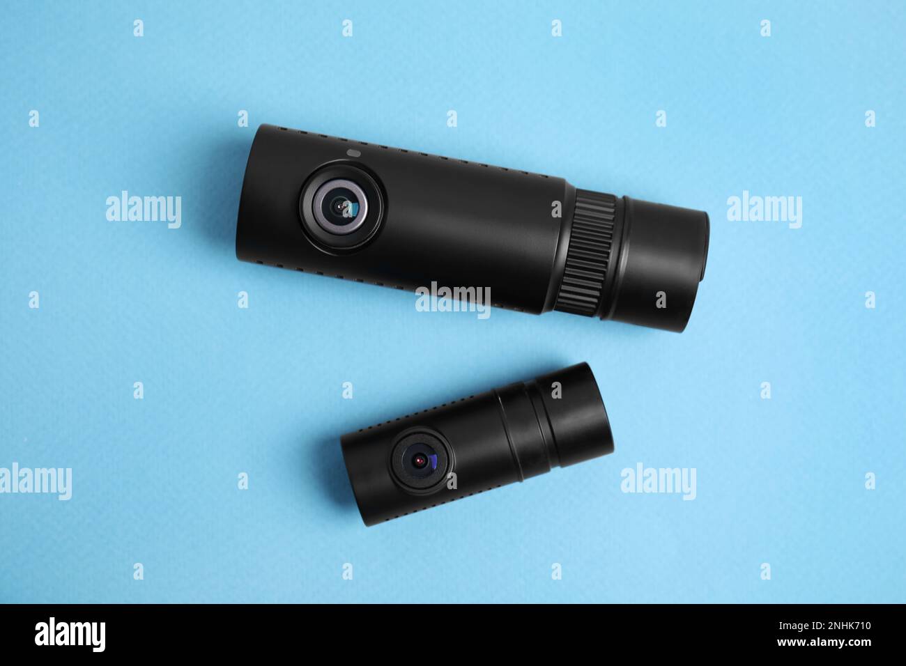 Black modern car cameras on turquoise background, flat lay Stock Photo